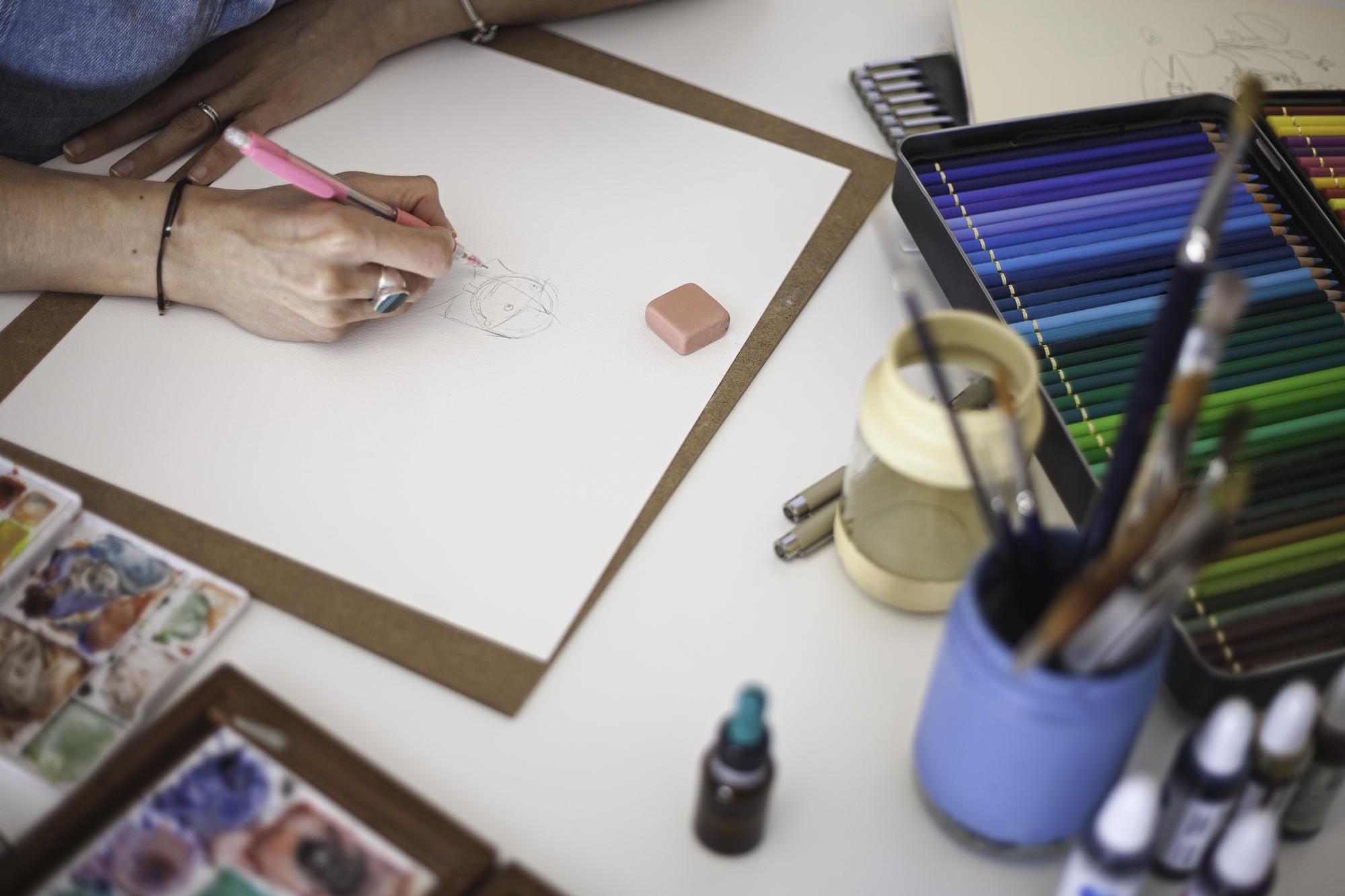 sketches and thread swatches on table