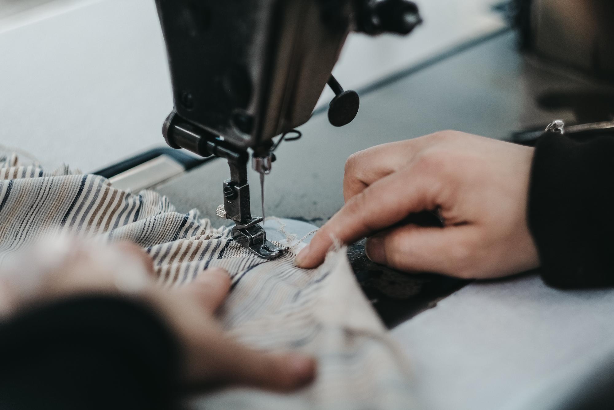 embroiderer at machine finishing a patch